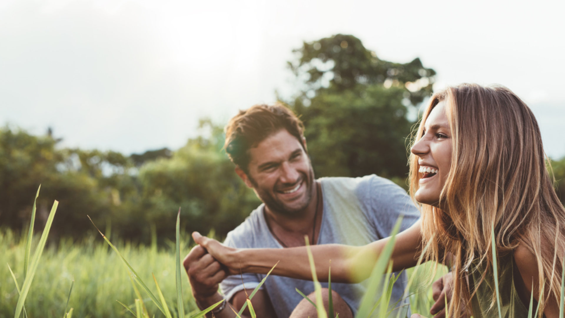 Couple laughing in a field
