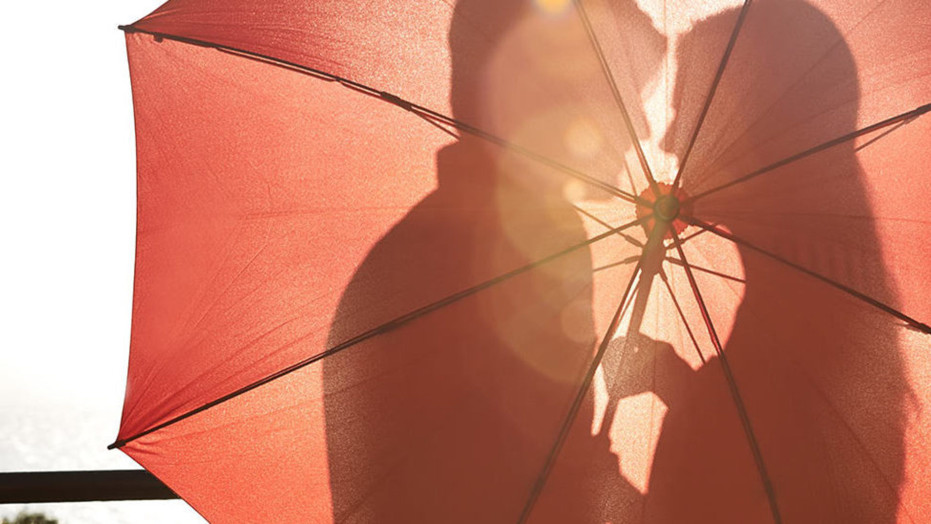 Couple behind an umbrella