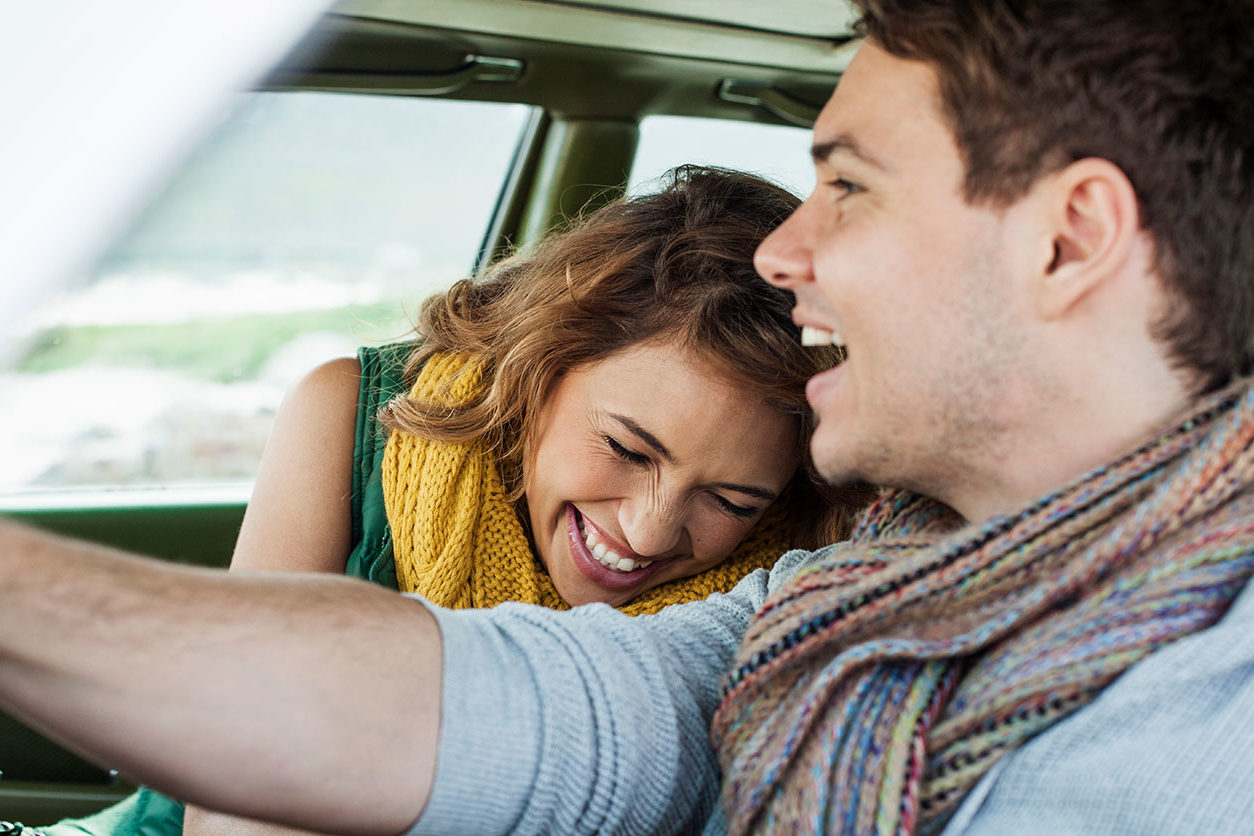 Couple laughing together in the car